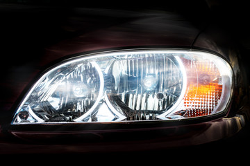 car headlight head light close-up front view, illuminated, bright