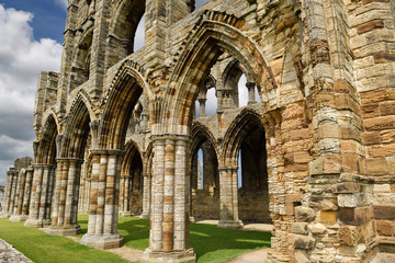 Eroded stones and pillars of the Gothic ruins of Whitby Abbey church chancel North York Moors...