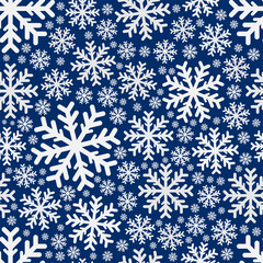 Seamless pattern. Beautiful white snowflakes isolated on a blue background. Vector drawing. Texture.