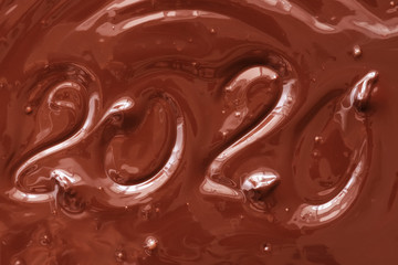 Liquid chocolate background with text 2020. The texture of melted chocolate. New Year concept.