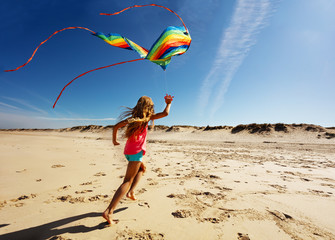 Girl run fast on beach hold color kite back view