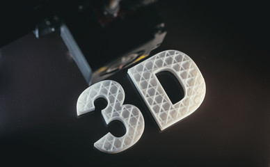 3D printers. 3D text white color ABS against black background,
