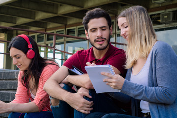 Group of  University students studying together outdoors