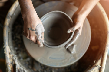 Woman making ceramic work with potter's wheel