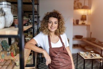 Portrait of woman pottery artist in art studio