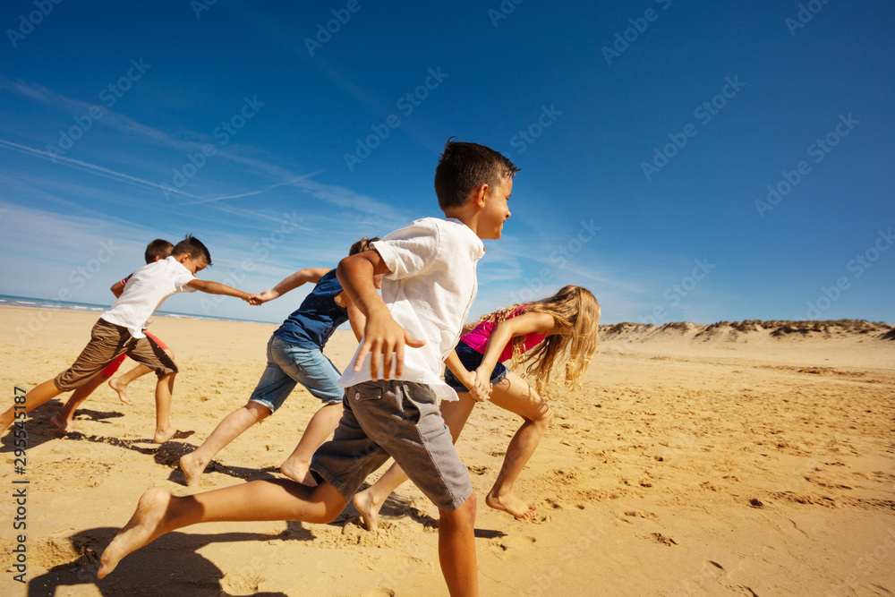 Canvas Prints boys and girls run on the beach holding hands