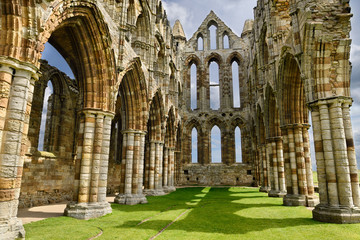 Chancel and wall of the Sanctuary of Gothic ruins of Whitby Abbey church in sunshine North York...