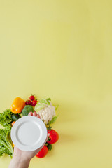 Plate for tasty diet on background Fresh vegetables . Top view. Food cooking background