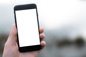 Close-up of smartphone with mockup in man hand.