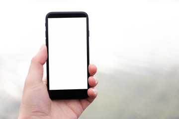 Close-up of smartphone with mockup in man hand.