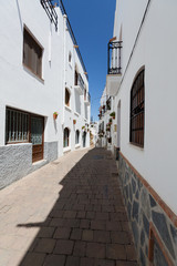 Fototapeta na wymiar Mojacar, Spain - Narrow Street with White Buildings