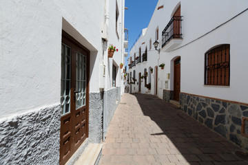 Fototapeta premium Mojacar, Spain - Narrow Street with White Buildings