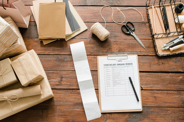 Top view of checklist order surrounded by packed gifts and wrapping items