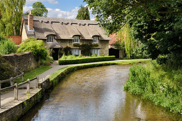 Beck Isle museum thatched roof cottage on the Thornton Beck stream in Thornton-le-Dale North Yorkshire England