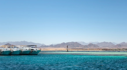 White yachts tourists in Red sea Tiran island Bay Akaba near Sharm El Sheikh in Egypt