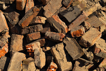 Old red brick. Construction garbage. Background and texture destruction.