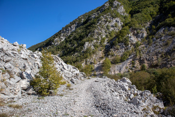 Fototapeta na wymiar Footpath next to the rocks and mountains and Una river in village Martin Brod in Bosnia and Herzegovina