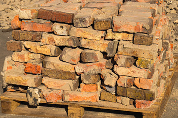 Old red brick. Construction garbage. Background and texture destruction.