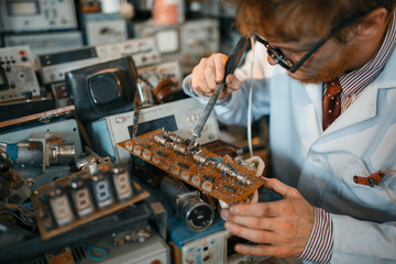 Strange scientist soldering chips, test in lab