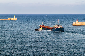 Cargo ship at the entrance to Grand Harbour in Malta
