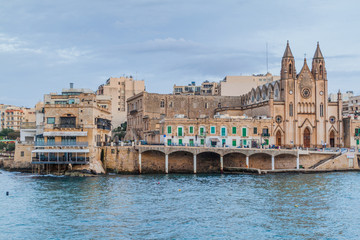 Fototapeta na wymiar Sliema waterfront with the Church of Our Lady of Mount Carmel, Malta