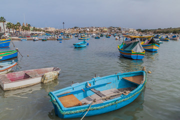 Fototapeta na wymiar Fishing boats in the harbor of Marsaxlokk town, Malta