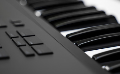 Professional midi keyboard synthesizer with knobs and controllers.