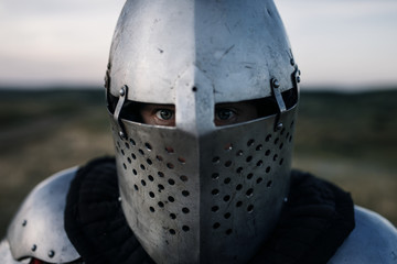 Medieval knight in armor and helmet closeup view