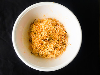 Noodles in a black background cup