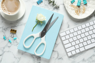 Flat lay composition with scissors, coffee and keyboard on white marble table