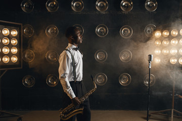 Black jazz musician with saxophone on the stage