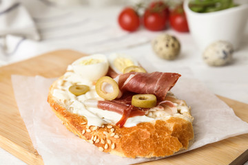 Cutting board with delicious bruschetta on table, closeup view
