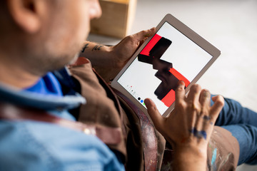 Contemporary artist painting something abstract on touchpad display