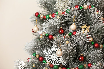 Beautiful Christmas tree with decor against light background, closeup