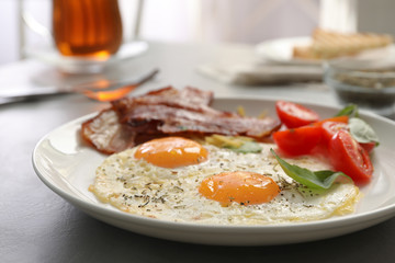 Tasty breakfast with fried eggs on grey table, closeup