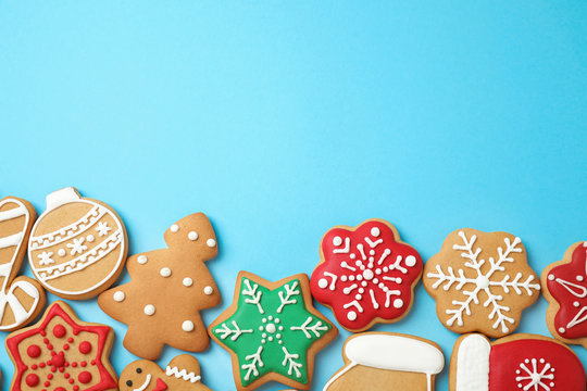 Flat lay composition with tasty homemade Christmas cookies on light blue background, space for text