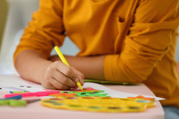 Little child drawing at table indoors, closeup. Christmas season