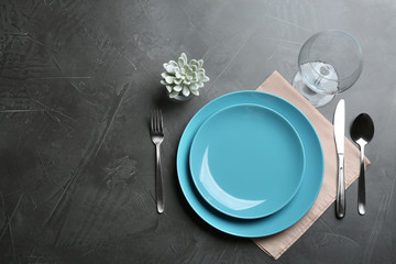 Elegant table setting on grey background, flat lay. Space for text