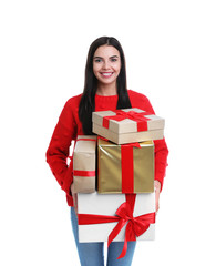 Fototapeta premium Happy young woman holding Christmas gifts on white background