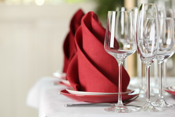 Table setting with empty glasses, plates and cutlery on table