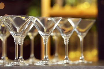 Empty martini glasses on table against blurred background