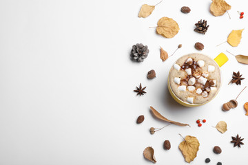 Composition with cup of hot drink on white background, top view. Cozy autumn atmosphere