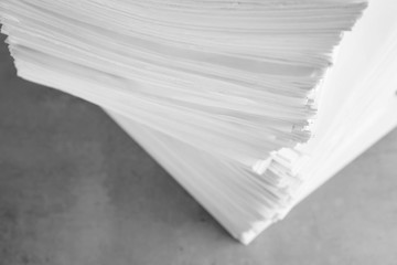 Fototapeta premium Stack of blank paper on grey stone table, above view