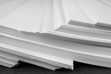 Stack of blank paper on grey stone table, closeup