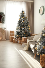 Stylish Christmas interior with beautiful decorated tree and gift boxes