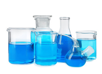Laboratory glassware with blue liquids isolated on white