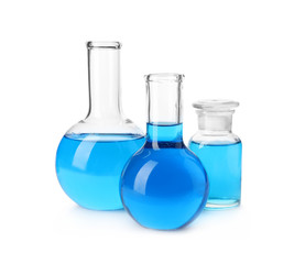 Laboratory glassware with blue liquids isolated on white
