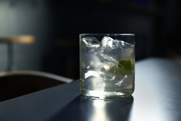 Glass of delicious cocktail with vodka on counter in bar