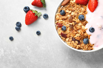 Tasty homemade granola served on grey table, flat lay. Healthy breakfast