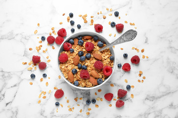 Fototapeta na wymiar Tasty homemade granola with berries on white marble table, top view. Healthy breakfast